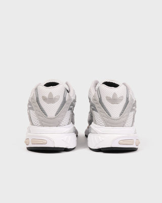 Pair of grey Adistar Cushion sneakers by Adidas viewed from the back, featuring the black Trefoil logo on each heel. Equipped with an Adiprene midsole for superior comfort, these shoes blend classic style with modern cushioning.