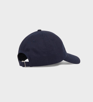 The Rebound Hat - Navy/Clean Mint is a unisex cotton twill cap with an adjustable strap and metal buckle, shown from the back on a white background. It offers comfort and classic style.
