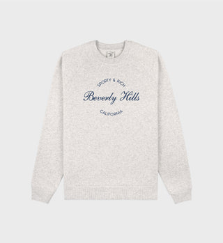 The Beverly Script Soft Crewneck in heather gray features Sporty & Rich Beverly Hills California in navy on the front, highlighting quality Portuguese craftsmanship.
