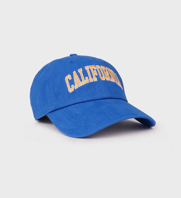 Side view of blue baseball cap with 'CALIFORNIA' embroidered in yellow letters across the front, featuring a curved brim