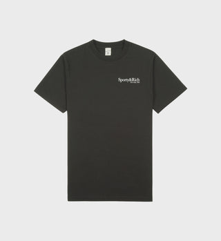 Faded black T-shirt with white 'Sporty & Rich' text on the left chest, featuring a crew neckline and short sleeves.