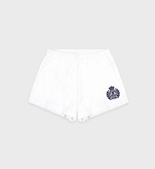 The H&W Crest Embroidered Disco Short in White/Navy is made from 100% cotton heavy jersey, with an elastic waistband and a navy crest emblem on the left leg, shown against a plain background.