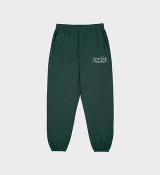 Green sweatpants with text on a light gray background