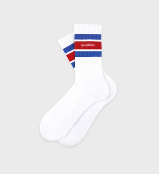 White athletic crew socks with red and blue stripes around the cuff, featuring 'Sporty & Rich' text on the red stripe.