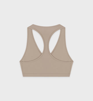 Luxurious Serif Logo V Neck sports bra in Elephant/White displayed on a plain white background.