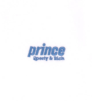 The Prince Sporty Terry Short - White/Lapis features a blue Sporty & Rich logo on plain white cotton. Made in Portugal from 100% terry cotton, these shorts offer both comfort and style.