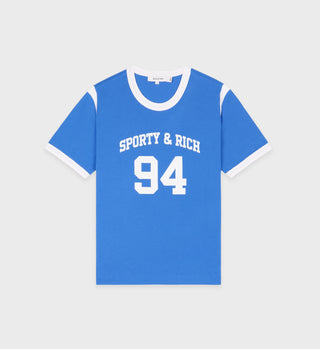 The SR 94 Sports Tee - Blue/White features a blue design with white collar and sleeve edges, SPORTY & RICH 94 in bold white letters on the front, and offers pre-shrunk comfort that stays perfect wash after wash.