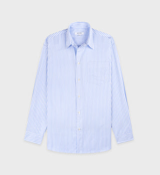 The SRC Oversized Shirt, crafted in Portugal, features light blue and white vertical stripes on a gray background.