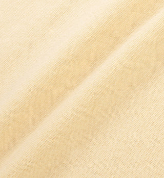 Close-up of the SR Runner Soft Disco Short in Almond/Navy, featuring soft, light beige fabric with a textured weave, visible diagonal seam, and an elastic waistband for cozy comfort.