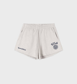 Heather grey disco shorts with an elastic waistband, side pockets, navy 'UCLA' text and seal on the right leg, and 'Sporty&Rich' text on the left leg.