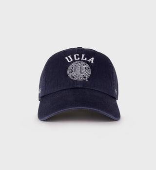 Navy baseball cap with white 'UCLA' text and the official UCLA seal embroidered on the front, featuring a curved brim.