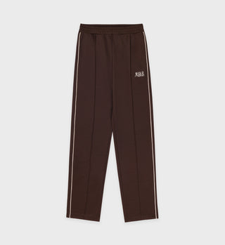 Action Logo Track Pants - Cocoa/Milk, featuring white side stripes and a small white embroidered logo on the left thigh, shown laid flat.
