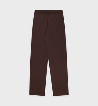 Action Logo Track Pants - Cocoa/Milk, featuring a straight-leg fit and elastic waistband, displayed flat on a plain white background.