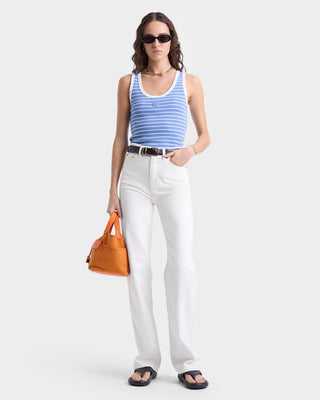 Woman wears the SRHWC Baby Tank in Juniper/White, styled with white jeans, sunglasses, and an orange handbag.