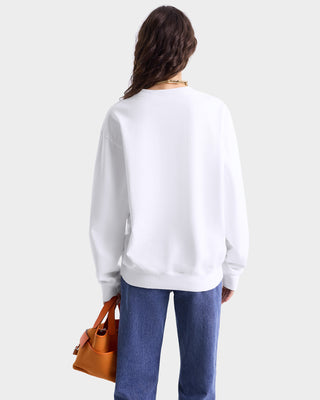 Back view of model wearing white crewneck sweatshirt