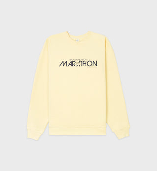 The Marathon Crewneck - Lemon is a pale yellow sweatshirt made from USA-grown cotton, featuring MARATHON and SPORTY & RICH text on the front. Made in Los Angeles.