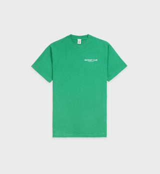The Racquet Club T-Shirt - Grass features BACQUET CLUB text in white on the left chest, made from soft USA-grown cotton, and is displayed on a plain background.
