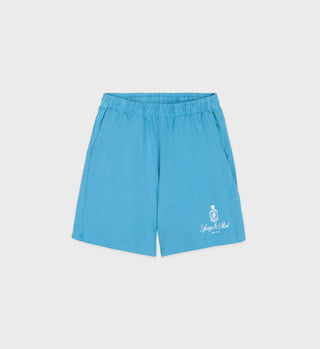 The Vendome Gym Short - Olympic Blue/White features an elastic waistband, white logo on the lower left leg, and is crafted from heavy jersey in Los Angeles for comfort and style. Shown against a clean white background.